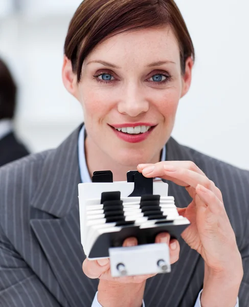 Portrait of a young businesswoman consulting her business card h — Stock Photo, Image