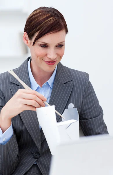 Businesswoman eating chinese food with chopstick — Stock Photo, Image