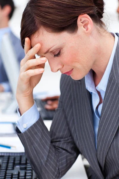 Attractive businesswoman suffering from a migraine — Stock Photo, Image