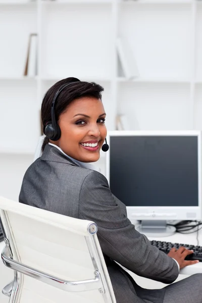 Ethnic businesswoman with headset on — Stock Photo, Image