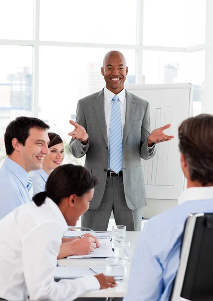 Empresário sorridente fazendo uma apresentação a seus colegas — Fotografia de Stock