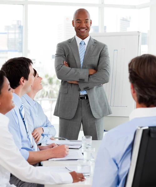 Confident manager reporting sales figures to his team — Stock Photo, Image
