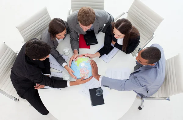 Internatonal Business team holding a terrestrial globe — Stock Photo, Image