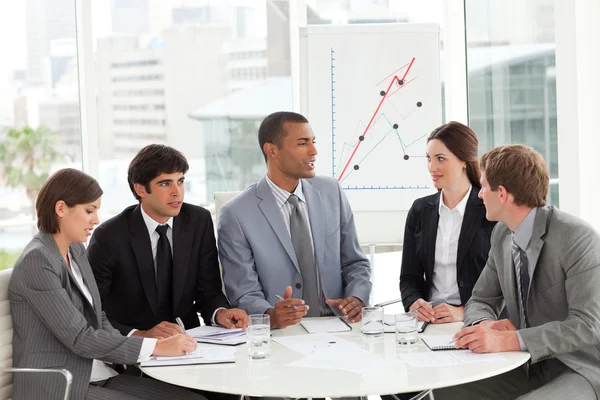 Business group studying sales report — Stock Photo, Image