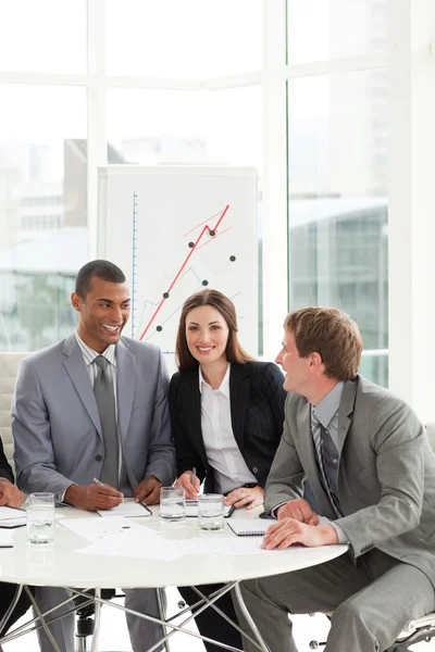 International co-workers sitting at a conference table — Stock Photo, Image