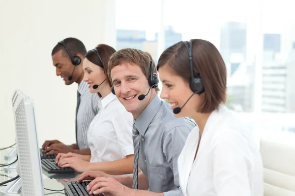 Young co-workers with headset on — Stock Photo, Image