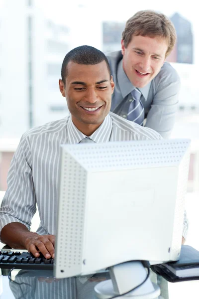 International partners working at a computer — Stock Photo, Image