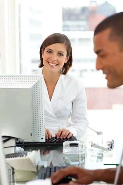 Portrait of a young businesswoman at a computer — Stock Photo, Image