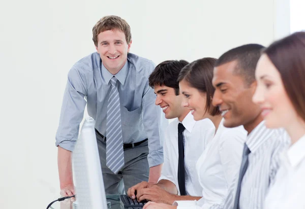 Self-assured manager and his team — Stock Photo, Image