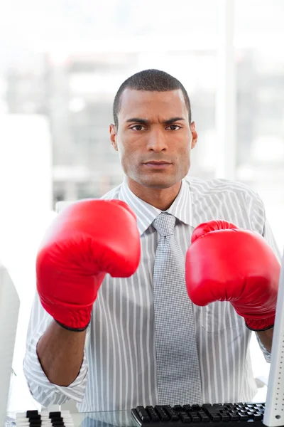 Serious businessman wearing boxing gloves — Stock Photo, Image
