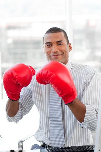 Empresário bem sucedido batendo a concorrência com luvas de boxe — Fotografia de Stock