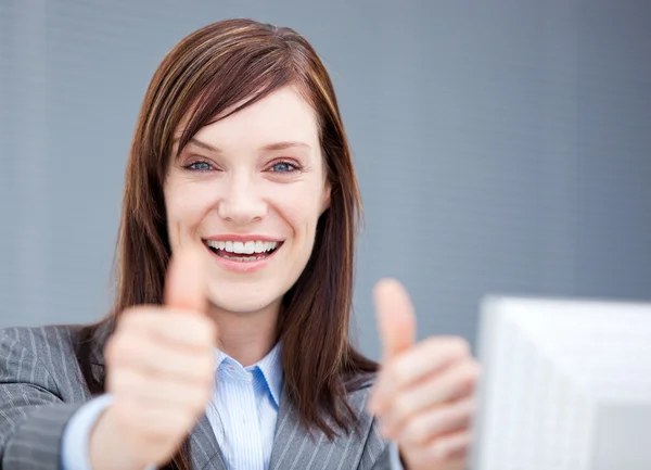 Jolly businesswoman with thumbs up — Stock Photo, Image