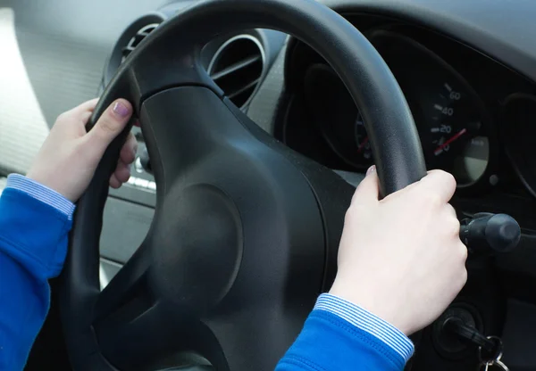Close-up of woman's hands on the wheel Stock Image