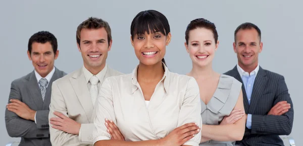Smiling multi-ethnic business team with folded arms — Stock Photo, Image