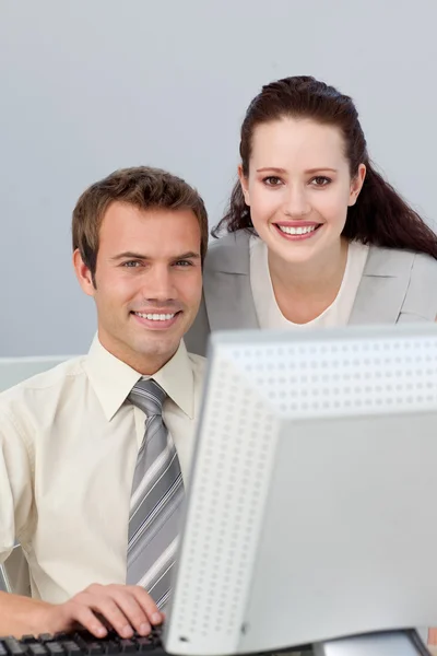Smiling businesswoman helping her colleague Stock Picture