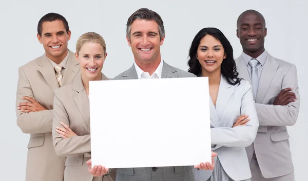 Business team holding a white card — Stock Photo, Image
