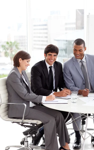 Young business sitting at a conference table — Stock Photo, Image