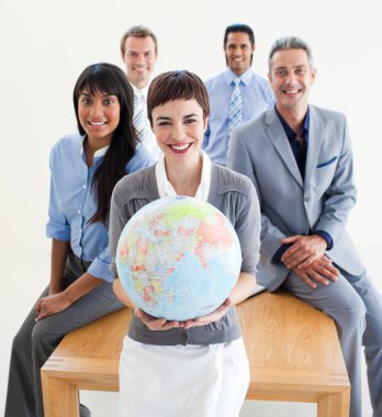 Cheerful multi-ethnic business holding a terrestrial glob clipart