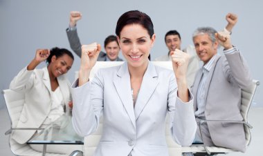 Happy business celebrating a sucess with hands up clipart