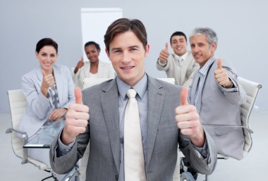 Attractive businessman celebrating a sucess with his team clipart