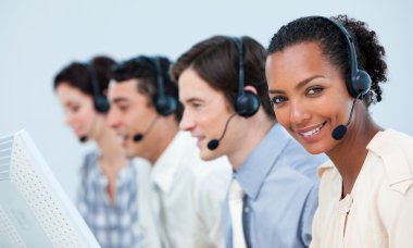 Multi-ethnic business using headset clipart