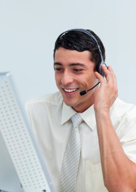 Latin businessman talking on headset clipart