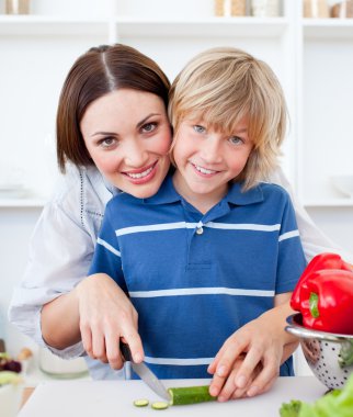 Attractive mother and her son cooking clipart