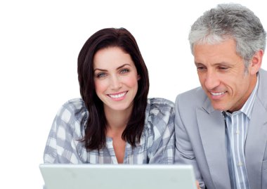 Two positive business co-workers using a laptop clipart