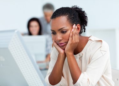 Bored businesswoman at her desk clipart