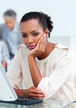 Bored businesswoman at her desk clipart