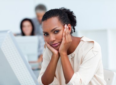 Bored young businesswoman at her desk clipart