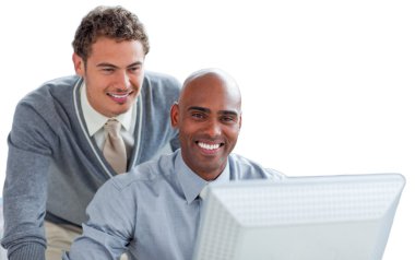 Two young businessmen working at a computer in the office clipart