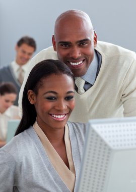 Portrait of two enthusiastic businesspeople working at a compute clipart