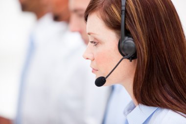 Close-up of a female customer service agent and her team clipart