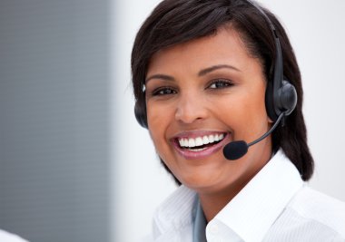 Portrait of an ethnic customer service agent at work clipart