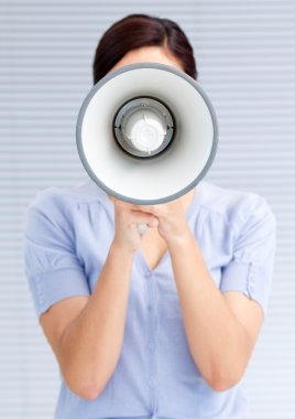 Businesswoman yelling through a megaphone clipart