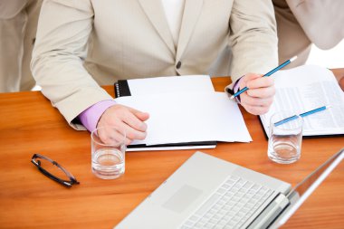 Close-up of a businessman working in a meeting clipart