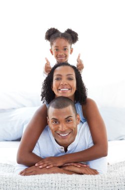 Adorable little girl having fun with her parents clipart