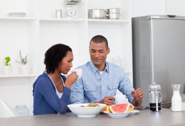 Smiling couple having breakfast together clipart