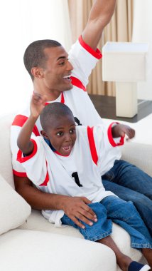 Happy father and his son celebrating a goal clipart