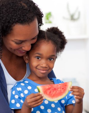 Portrait of a smiling girl eating fruit clipart