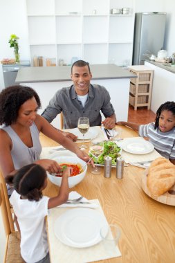 Ethnic family dining together clipart