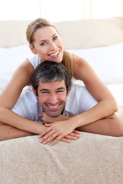 Enamoured couple lying on the bed clipart