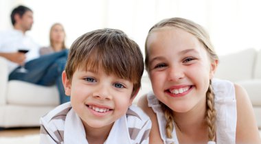 Smiling siblings lying on the floor clipart