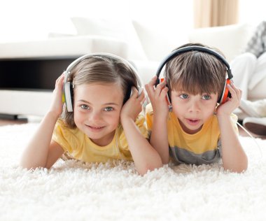 Close-up of children listening music with headphones clipart
