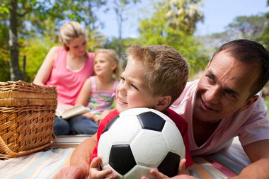 Happy family having fun at a picnic clipart