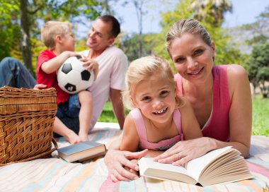 Happy young family enjoying a picnic clipart