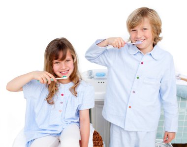 Cute children brushing their teeth clipart