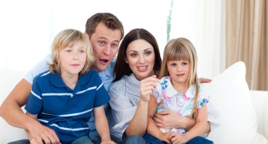 Ecxited family watching a rugby match clipart