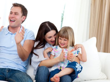Happy family clapping a goal clipart